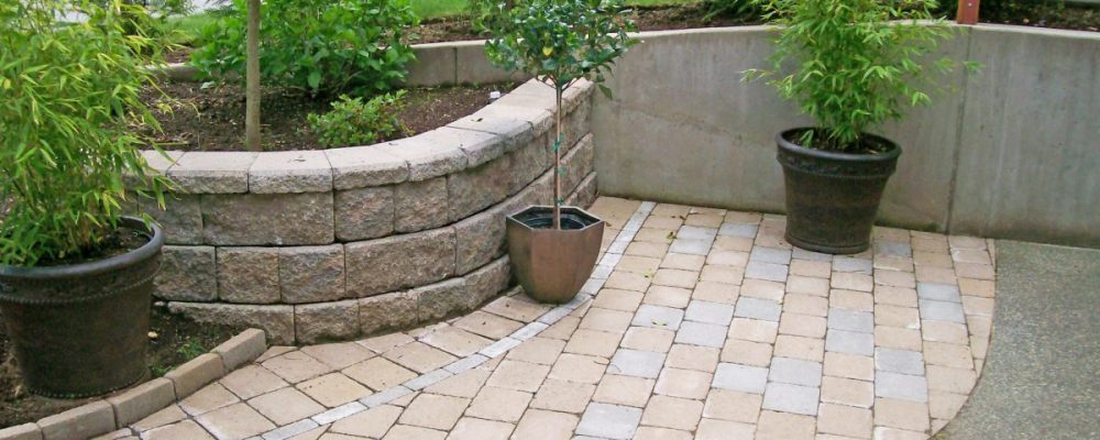 brick patio with stone planter and plants